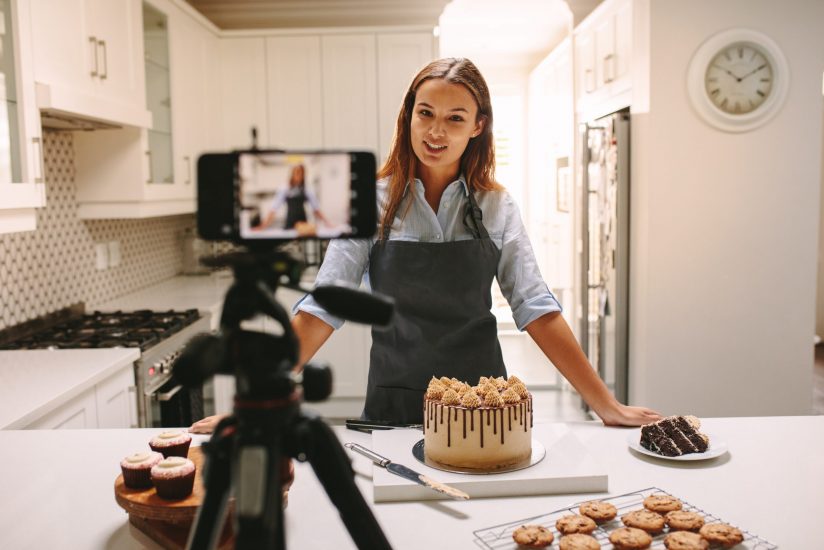 Young,Woman,Vlogger,Baking,And,Recording,Video,For,Food,Channel.